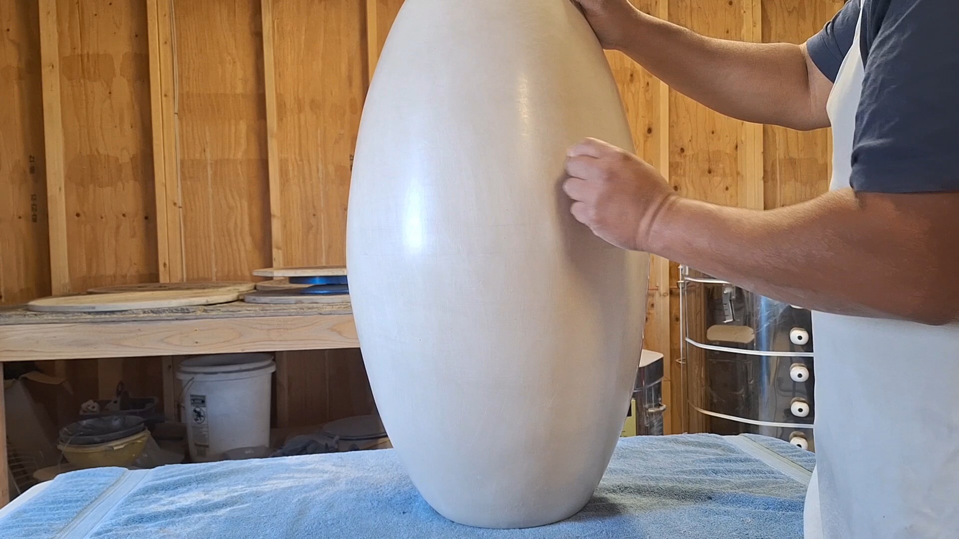 Hand polishing handcrafted pottery